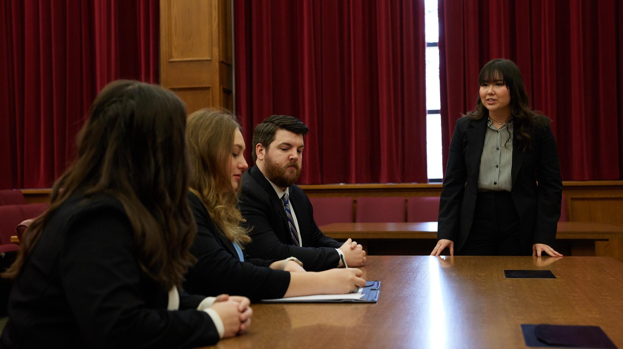 Students discussing strategy in courtroom.