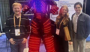 Students standing next to Clio Robot